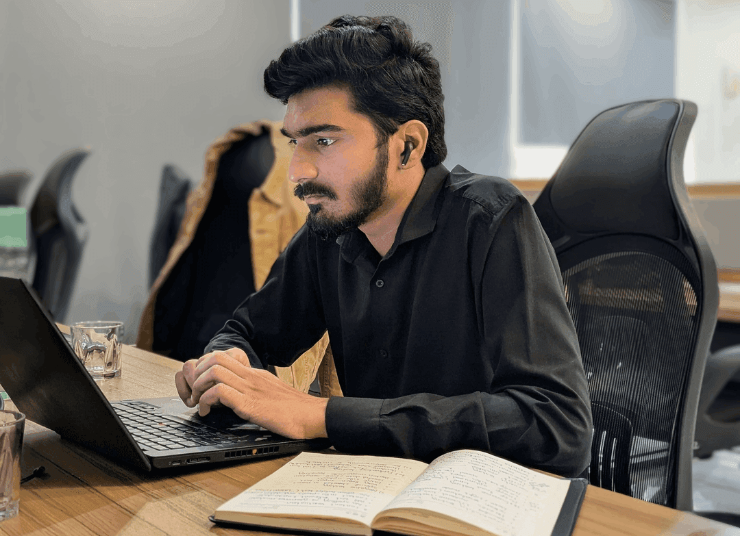 Innovaxel team member working on a laptop in the office